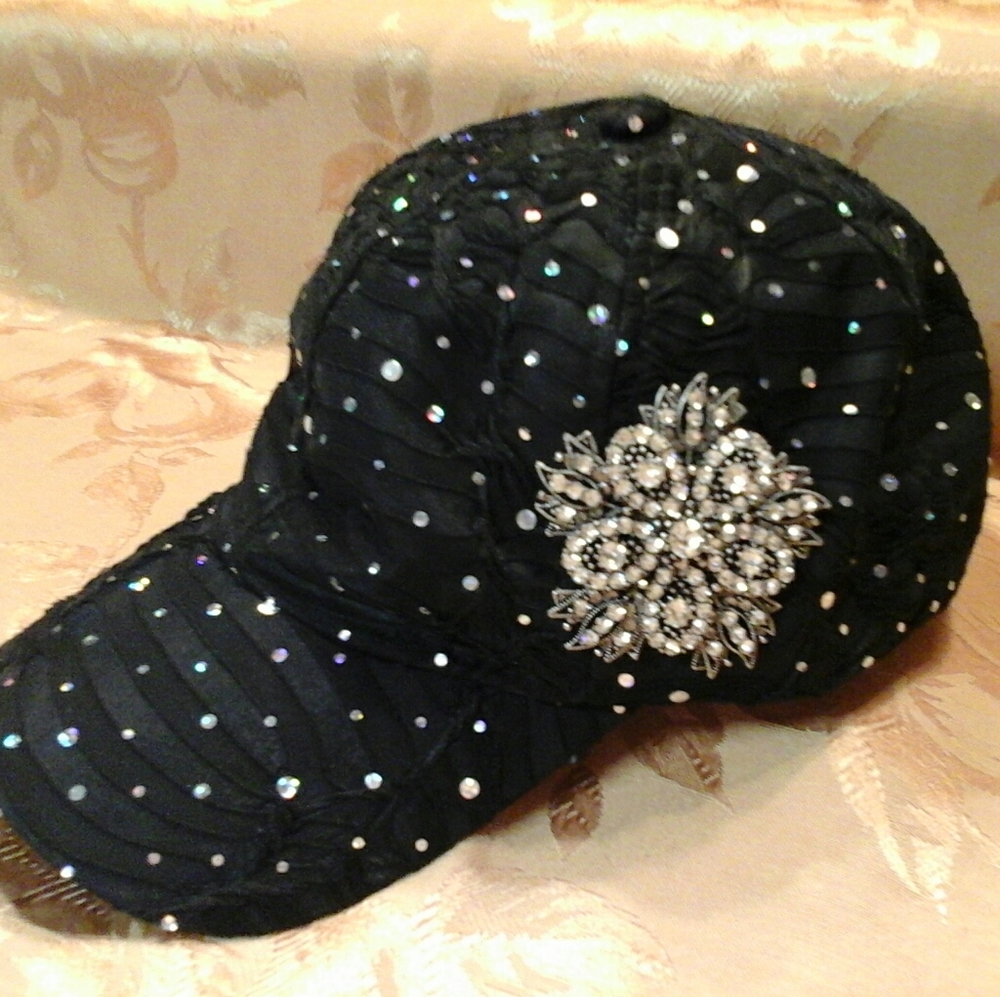 Ladies sparkle ball cap with jeweled pendent.